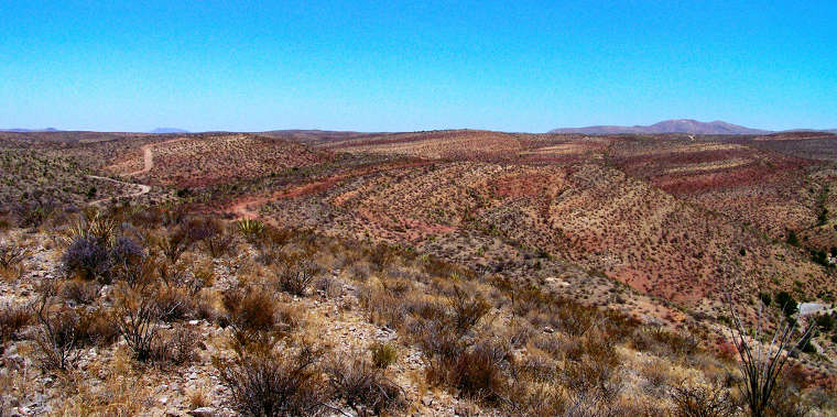 A view across the hills and multi-colored landscape of the Chihuahuan desert in the Robledo Mountains