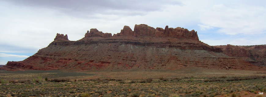A view of multi-colored cliffs on the side of a mesa along the Dead Horse Mesa Scenic Byway