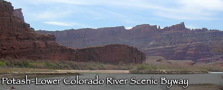 Looking across the Colorado River at red rock cliffs along the Potash-Lower Colorado River Scenic Byway