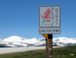 A Cloud Peak Skyway marker with the snowy Bighorn Mountains spine in the background