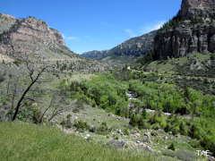 The U-shaped valley of Ten Sleep Canyon, complete with conifer forest, rushing stream and limestone cliffs rising above