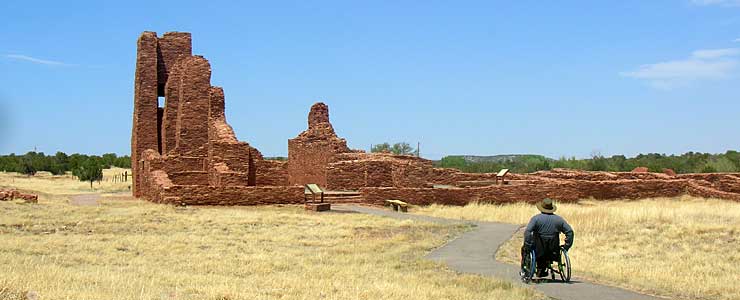 A man in a wheelchair approaches the mission ruins at Abo