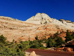 White cliffs rise above multicolored cliffs